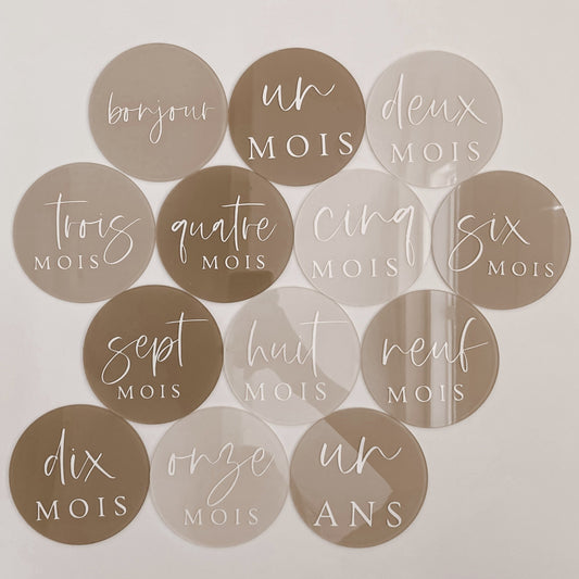 Set of thirteen French acrylic milestone discs in three neutral colours with with script font.